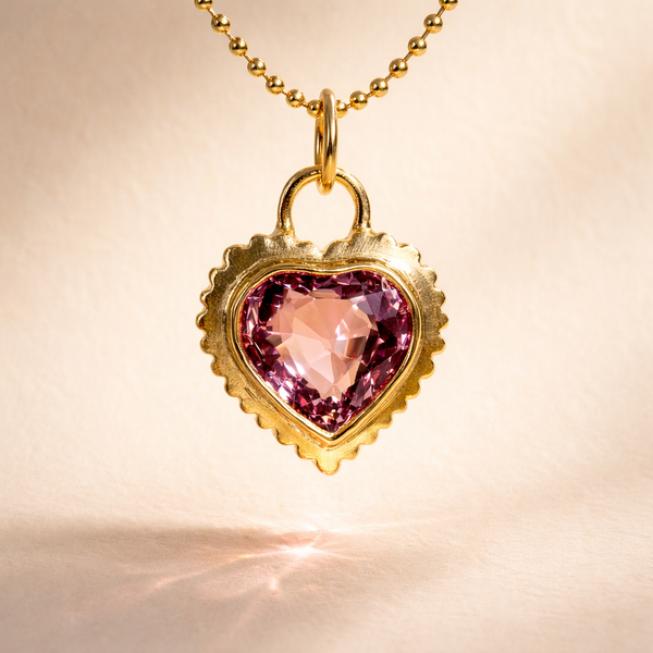 18k yellow gold charm featuring a pink heart cut garnet. Baby Rib Garnet Heart Charm front view. Perfect for luxury gift or handcrafted jewelry.