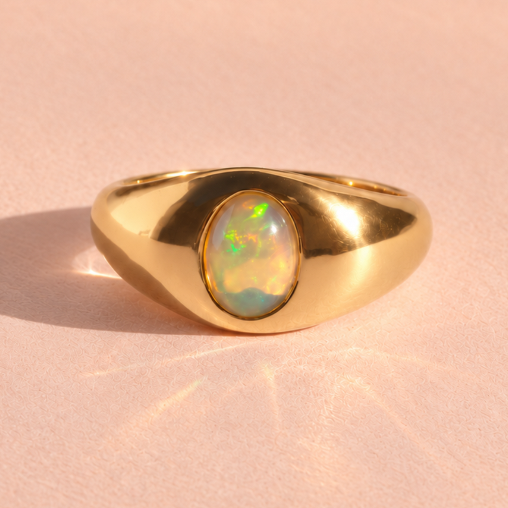 Opal Domed Cigar Band ring front view in 14k yellow gold, showcasing a captivating Australian opal. Handcrafted by Ruinette Bijoux, this fine jewelry piece embodies artisan elegance.